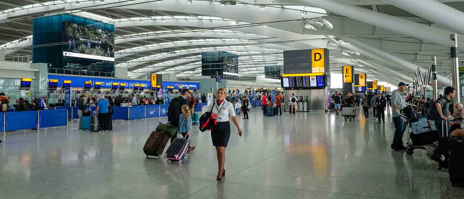 inside airport terminal interior air stewardess travellers suitcases