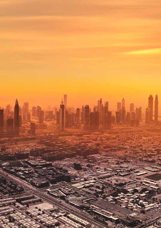Dubai city skyline Middle East red orange hazy sunset sky