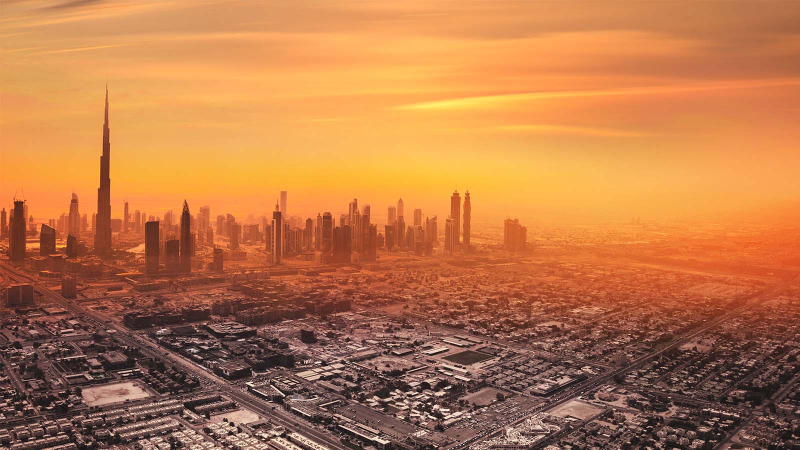 Dubai city skyline Middle East red orange hazy sunset sky