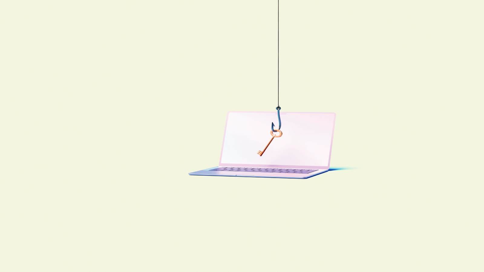 Laptop with key infront of screen hanging off hook