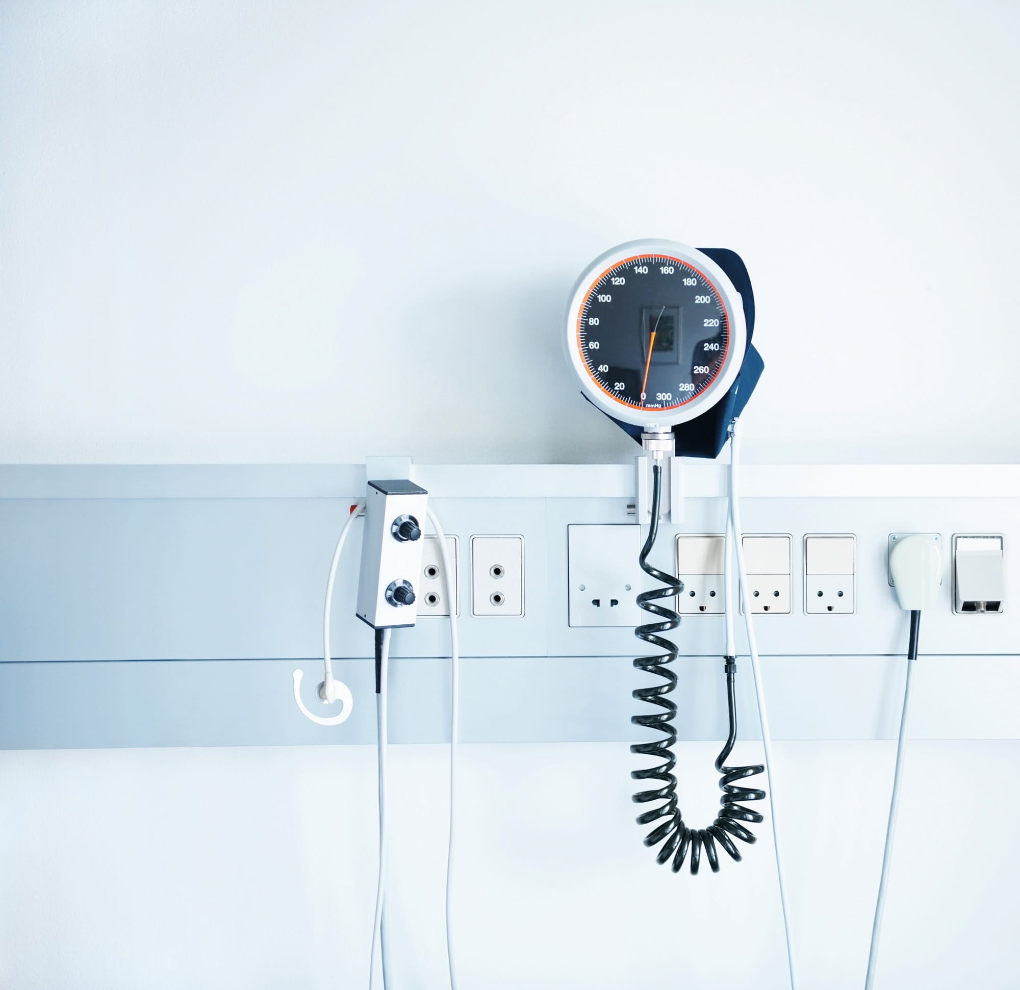 Image of a blood pressure monitor attached to the wall