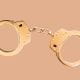 Handcuffs on orange background