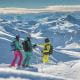 Image of skiers under blue skies