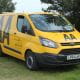 Yellow AA van parked on the grass