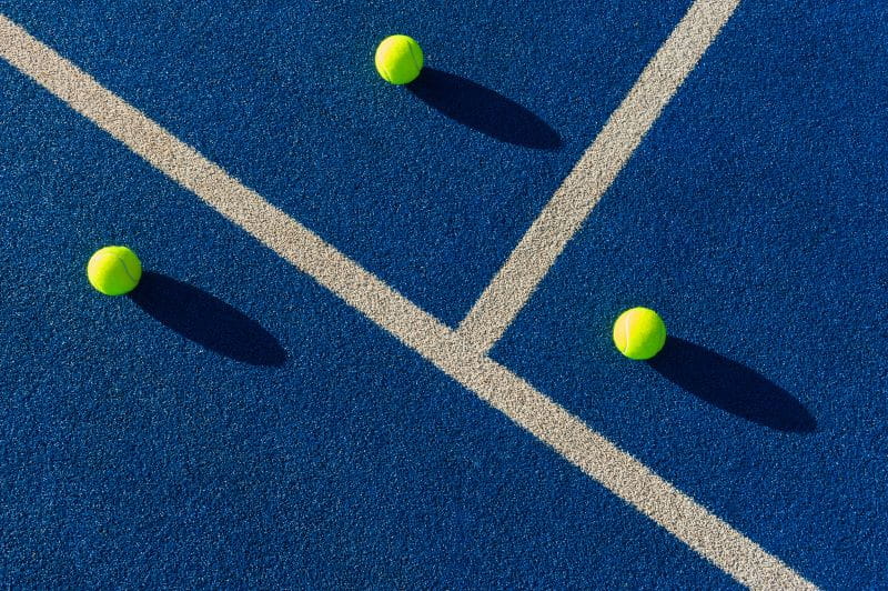 Image of three tennis balls on court