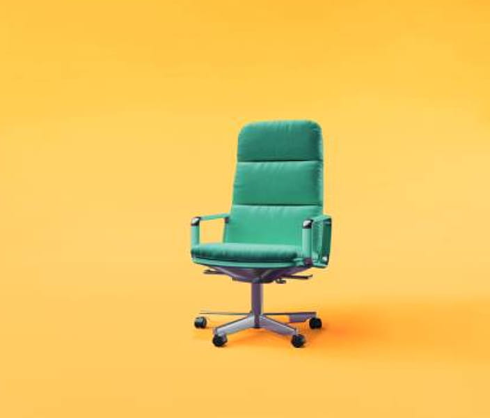 Green office chair on yellow background