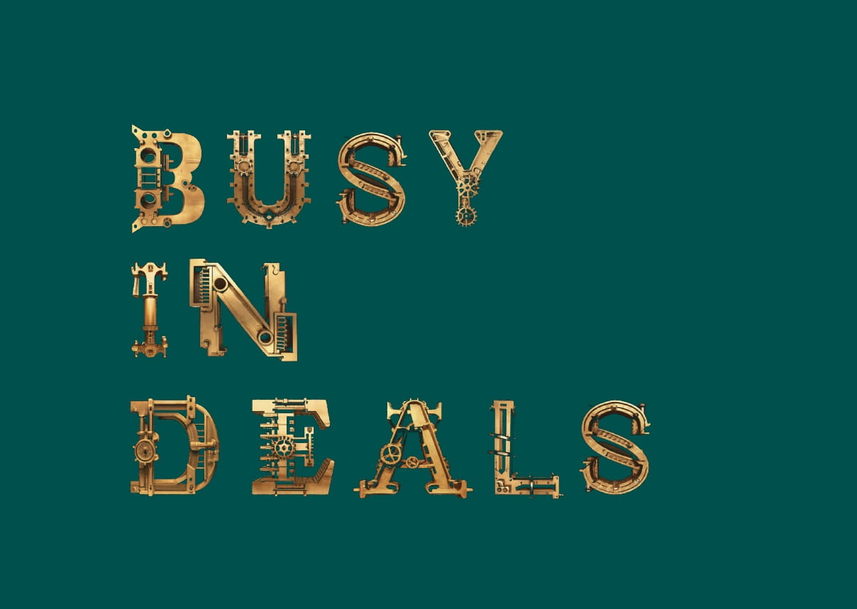 Text saying 'Busy in deals' in gold on a green background