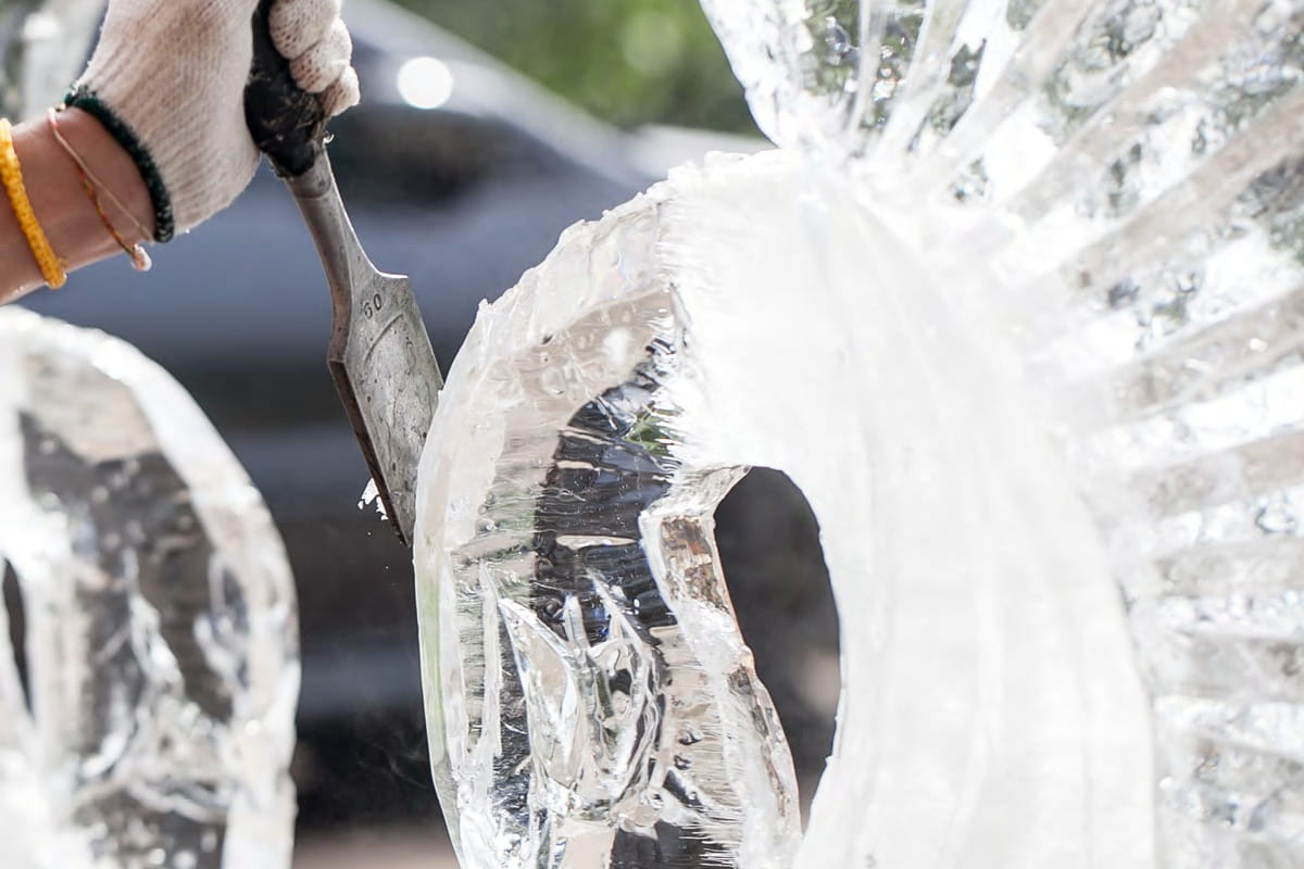 Person carving an ice sculpture
