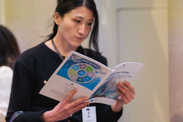 A member reading a booklet from the Corporate Governance Conference 2026