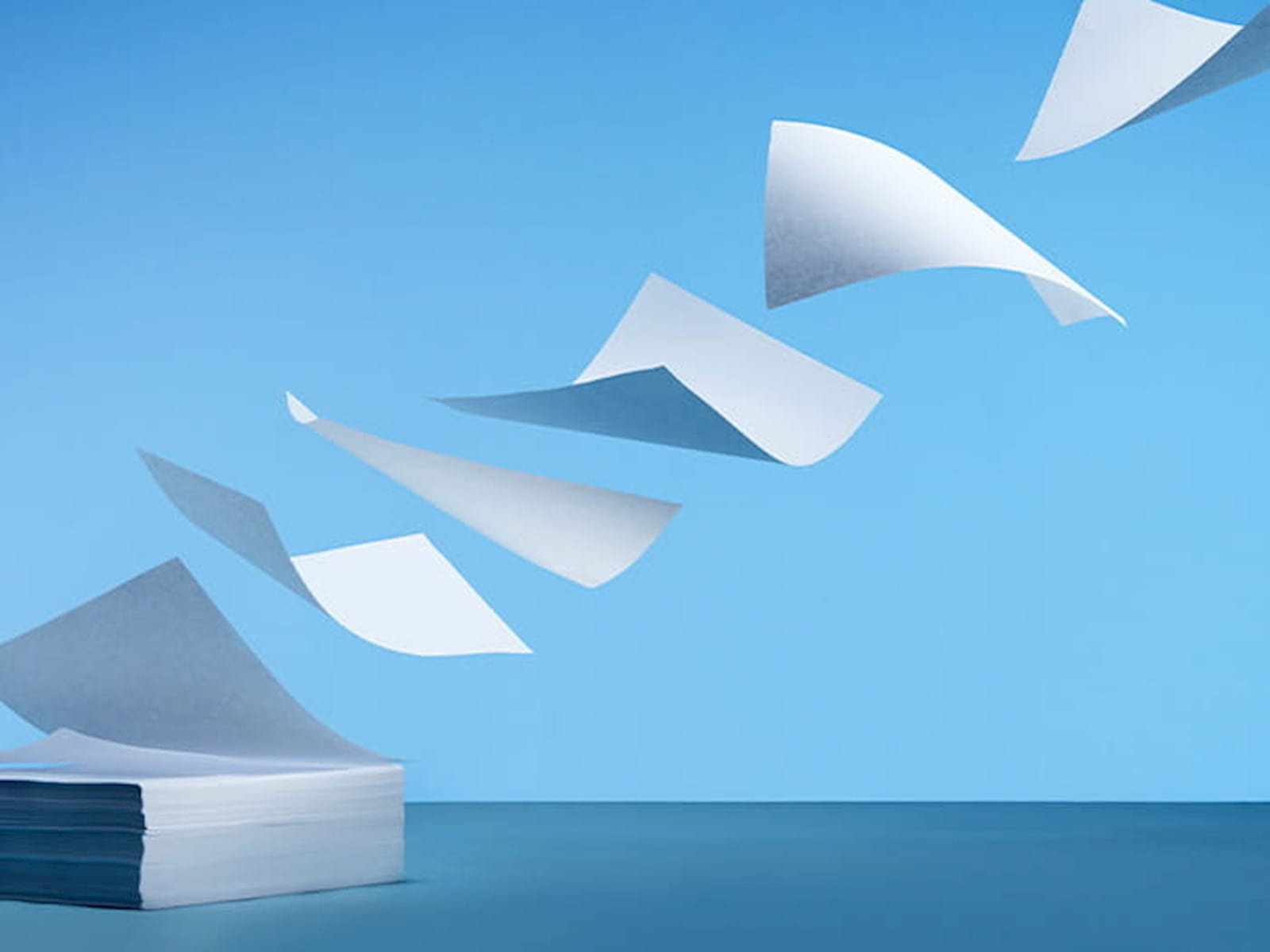 pile stack of paper flying off blue sky changes to account preparation