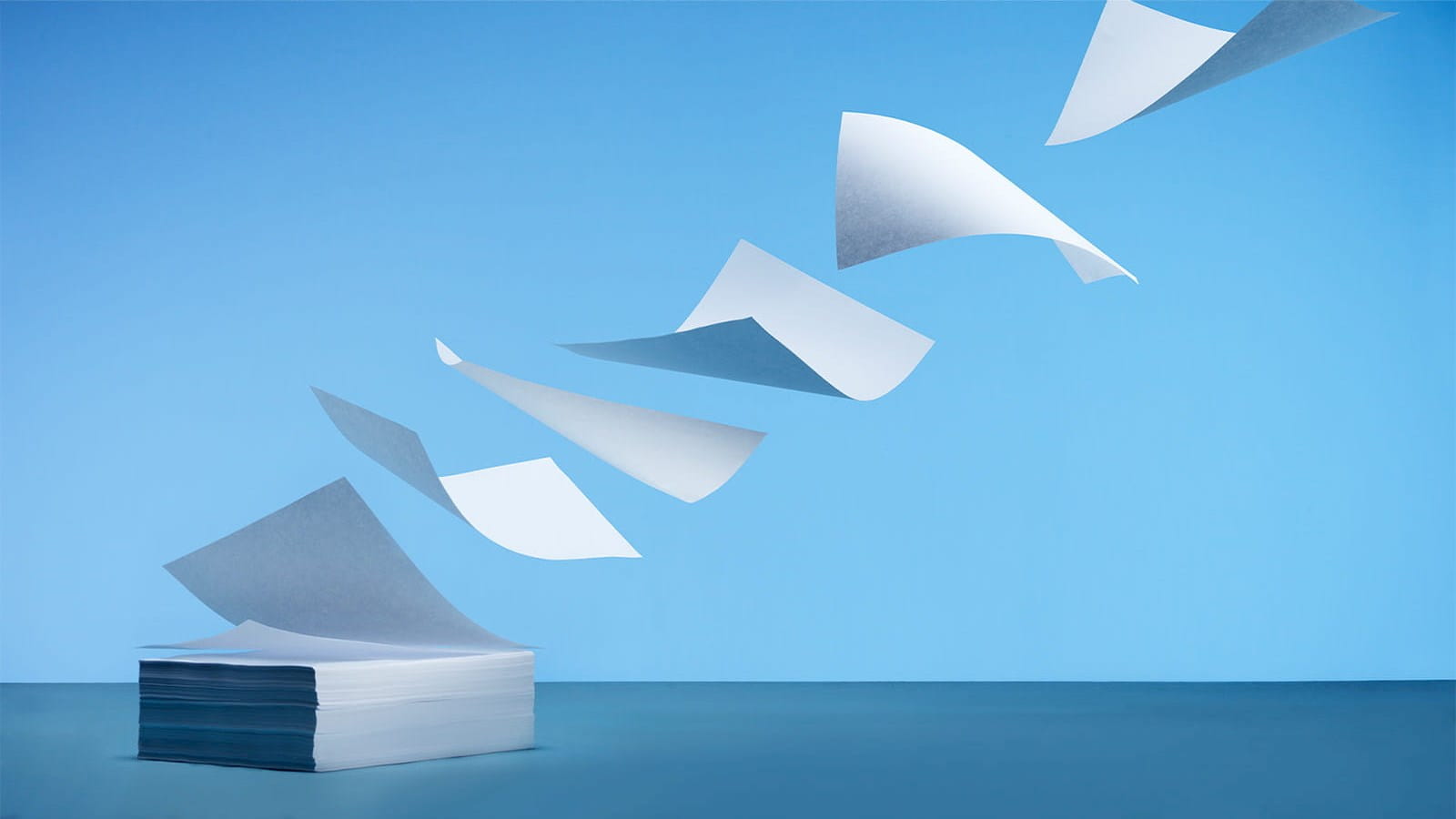 pile stack of paper flying off blue sky changes to account preparation