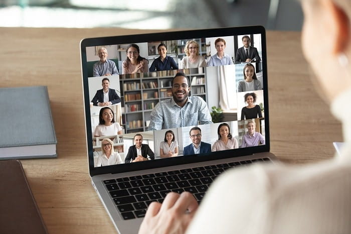 Laptop screen showing participants in an online meeting