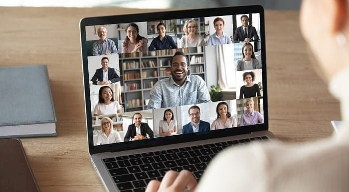 Laptop screen showing participants in an online meeting