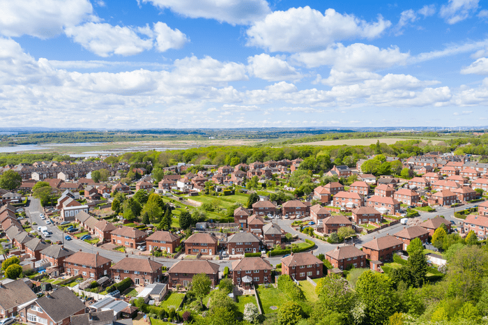 Arial view of housing surrounded by trees