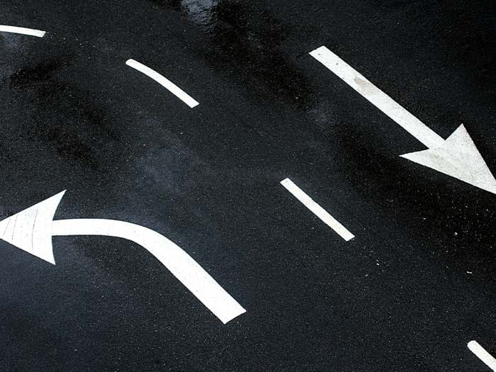 Painted white arrows on a road