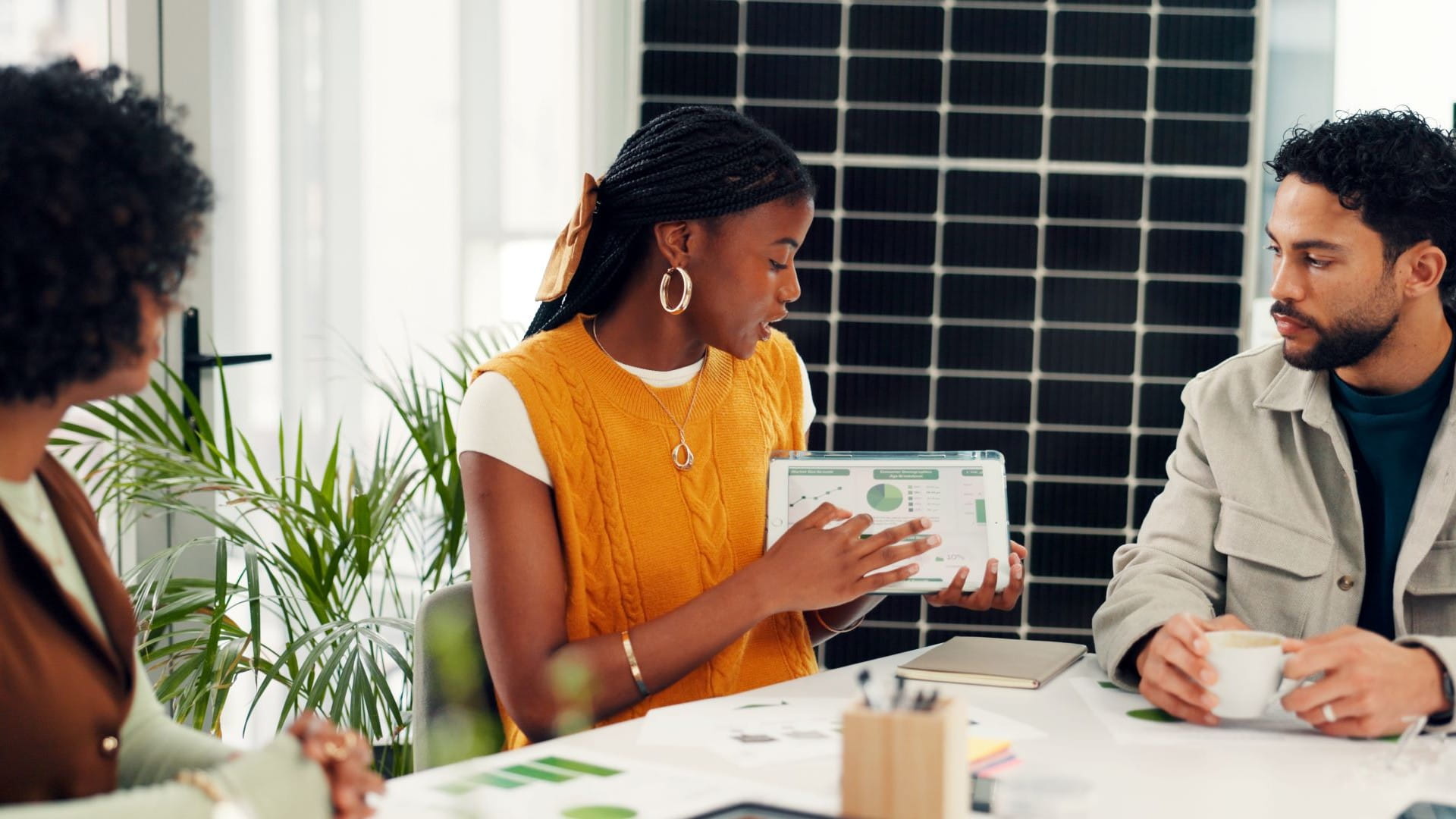 Office workers looking at report on a tablet