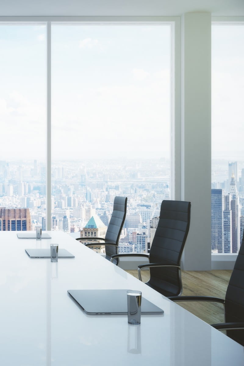 Empty boardroom with cityscape in background