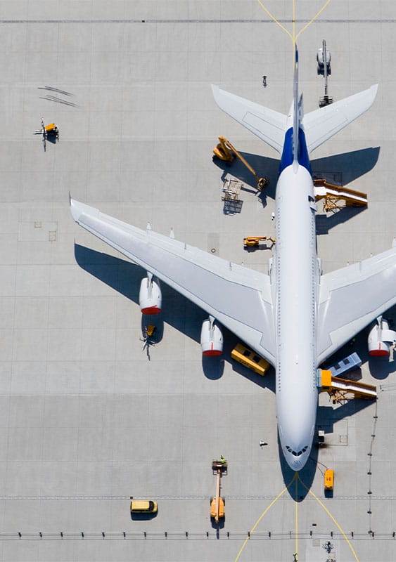 jet cargo plane on an airport tarmac seen from above aerial birds eye view being loaded for trade