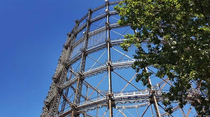 Gas works tower in front of a blue sky