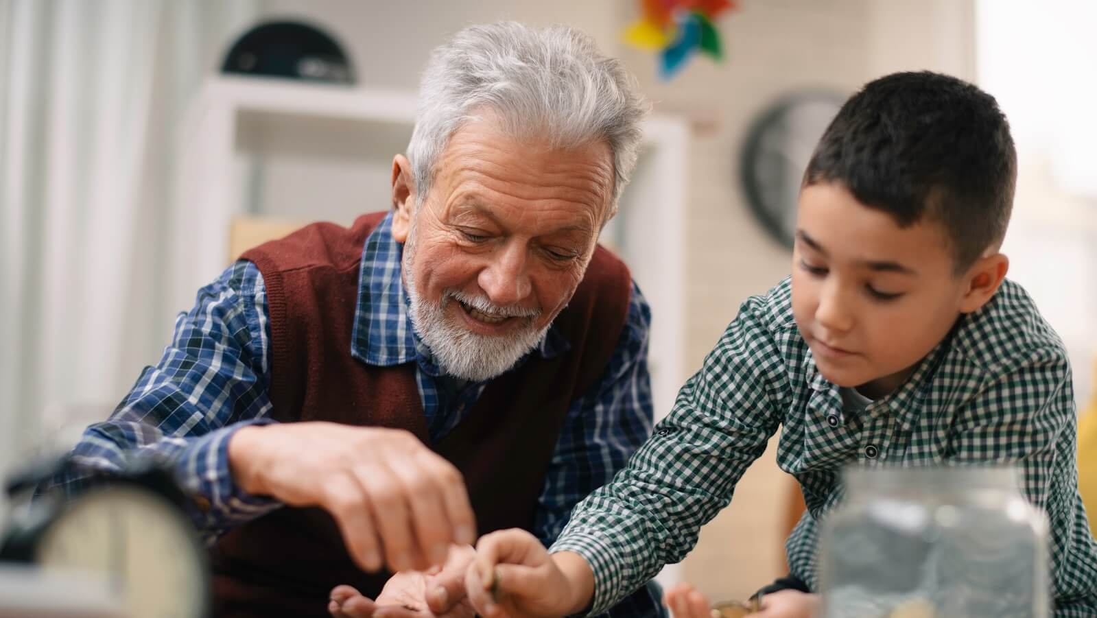 Elderly gentleman playing with grandson