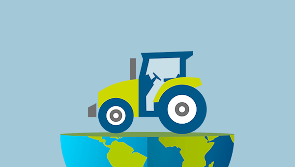 A tractor sitting on top of the bottom hemisphere of planet Earth