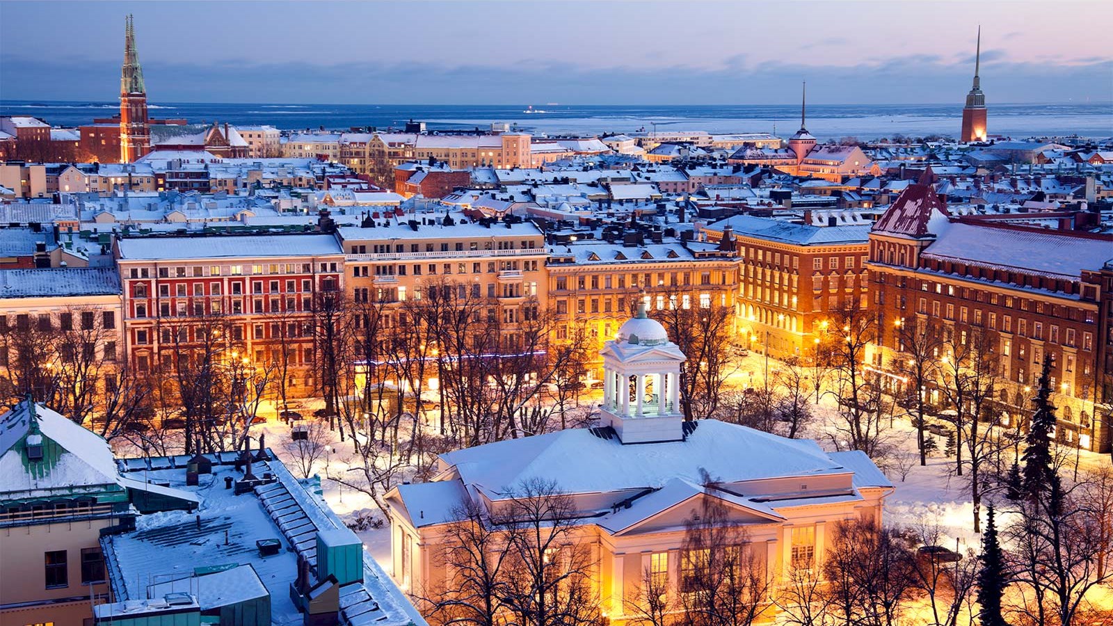 Helsinki Finland city skyline snow evening night lights winter tax conference