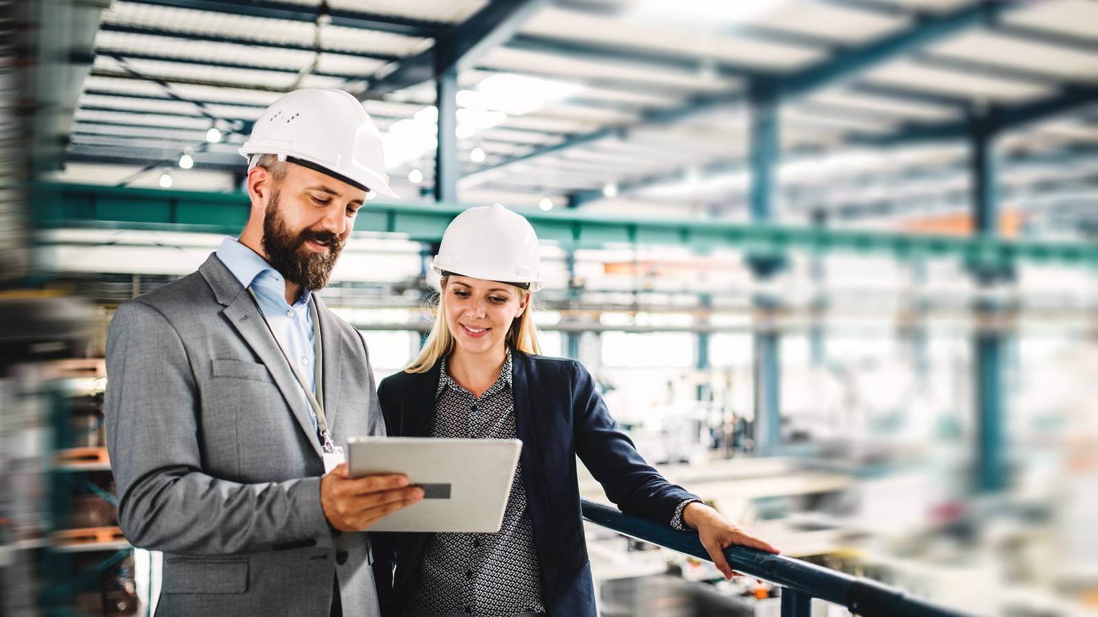 Male and female working in factory