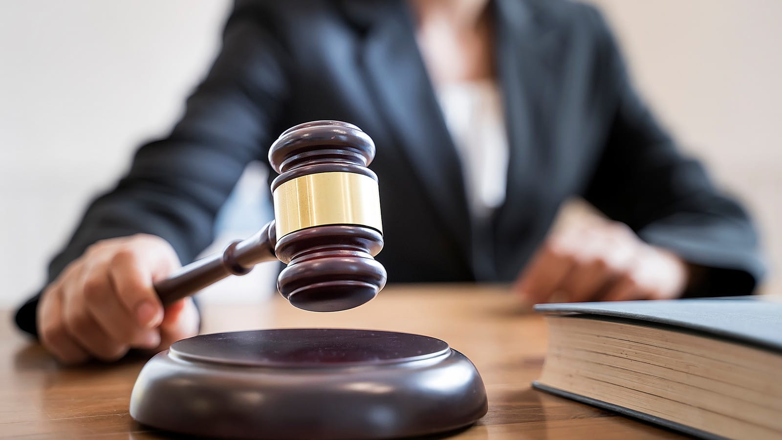 A female judge using a gavel in the court room