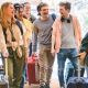 Young happy group travelling with suitcases