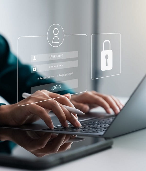 woman typing on a laptop and also using and iPad and apple pen