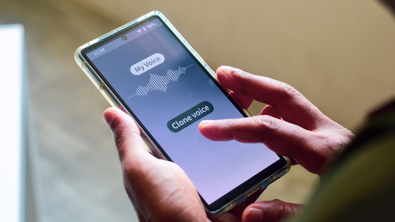 Person holding mobile phone with text saying my voice and clone voice
