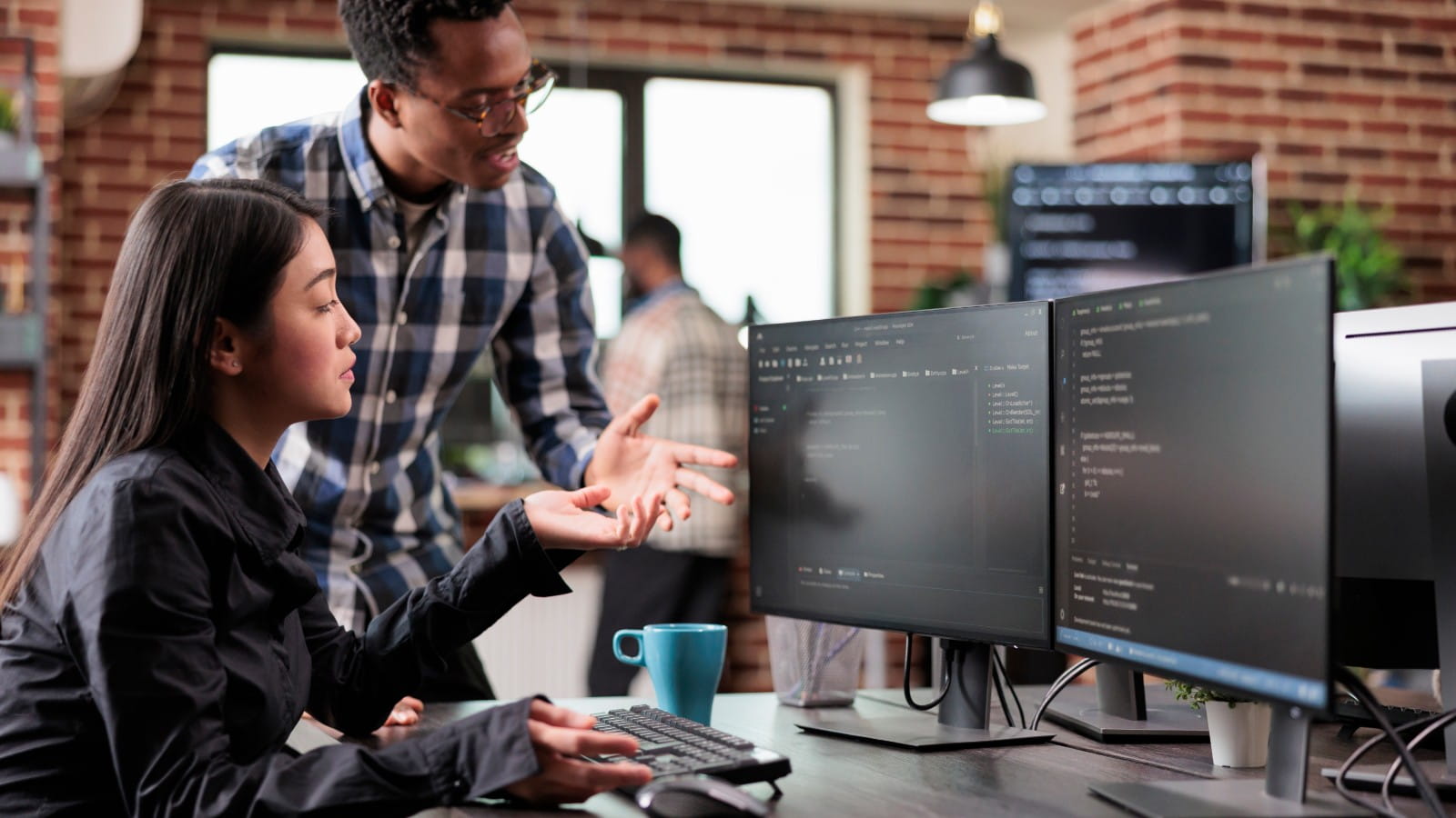 Two people looking at computer screens.