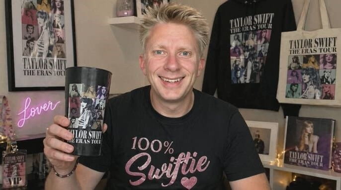 A smiling man holding a big cup