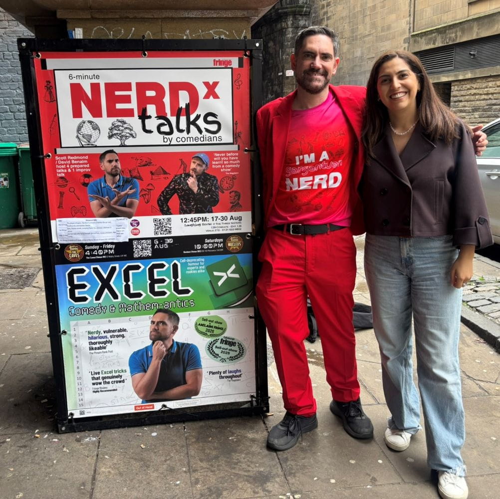 Photo of David Benaim and Fay Bordbar next to a poster of Excel Comedy act at Edinburgh Fringe