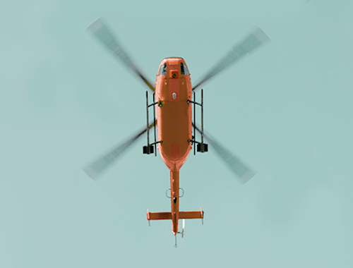 A red helicopter seen from below