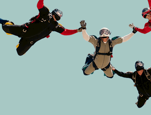 Skydivers holding hands