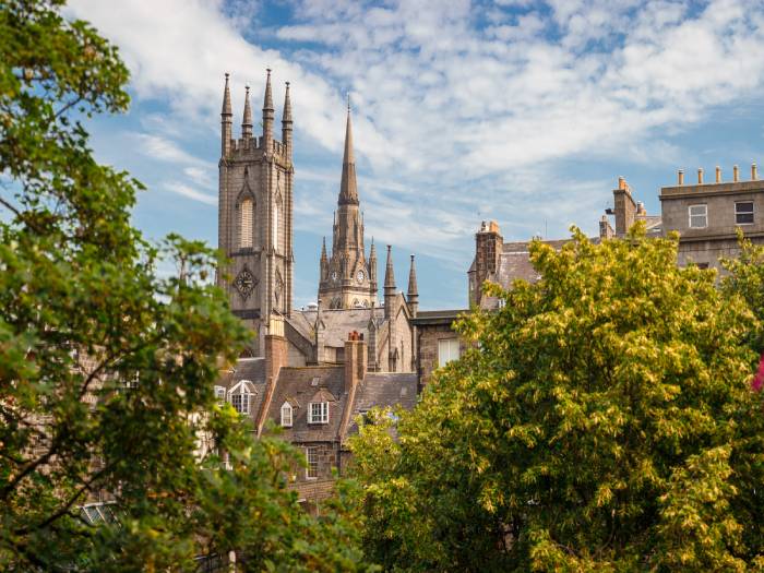 Former South Church with Kirk of St Nicholas in the background surrounded by trees in Aberdeen, Scotland