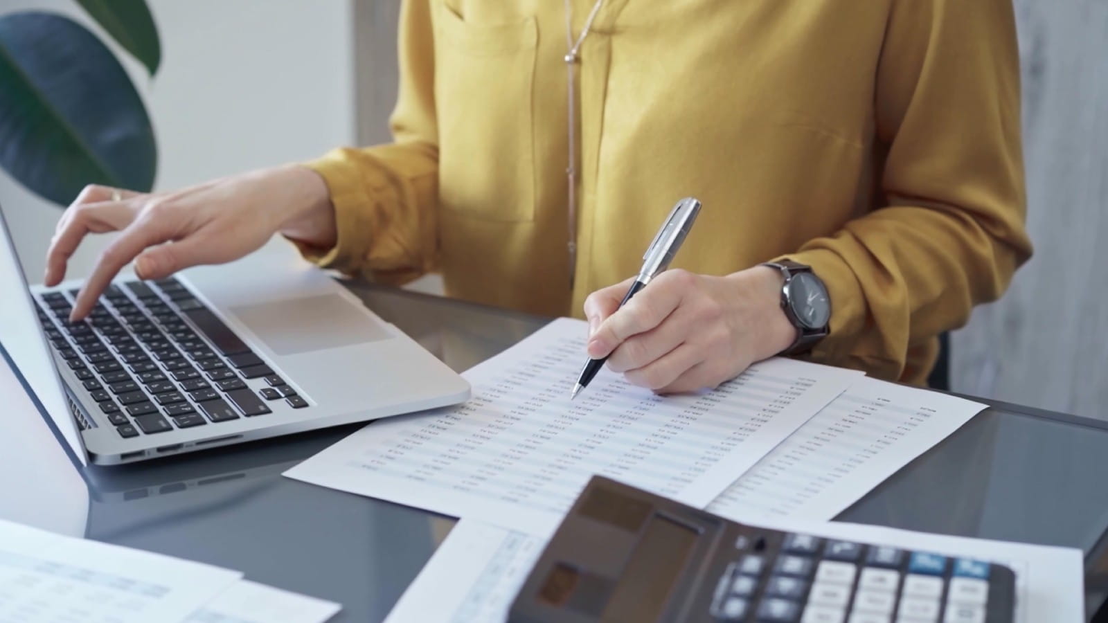Woman in yellow top doing accounts