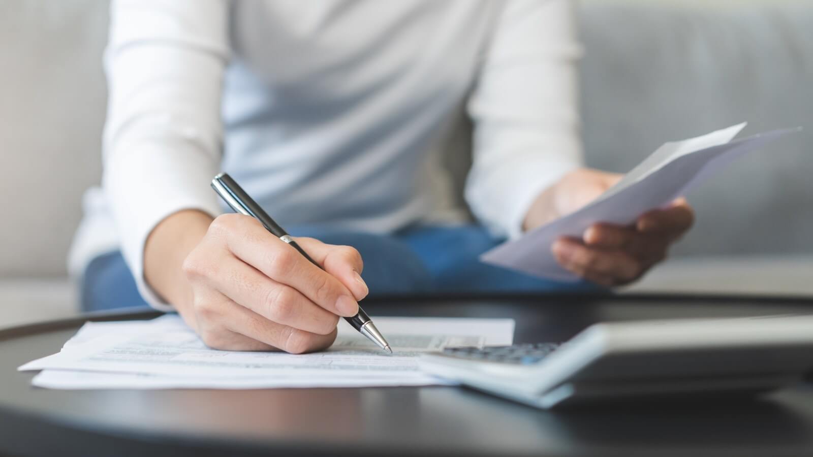 Woman holding receipts as she fills out a tax return