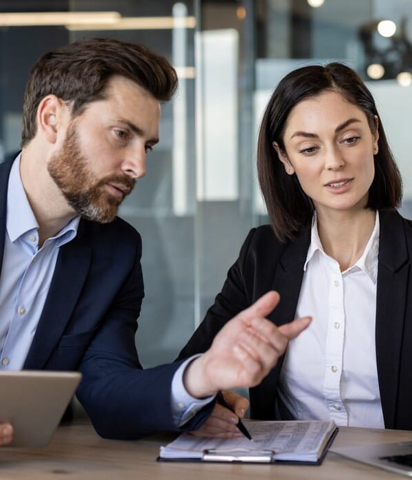 professionals discussing while looking at a screen
